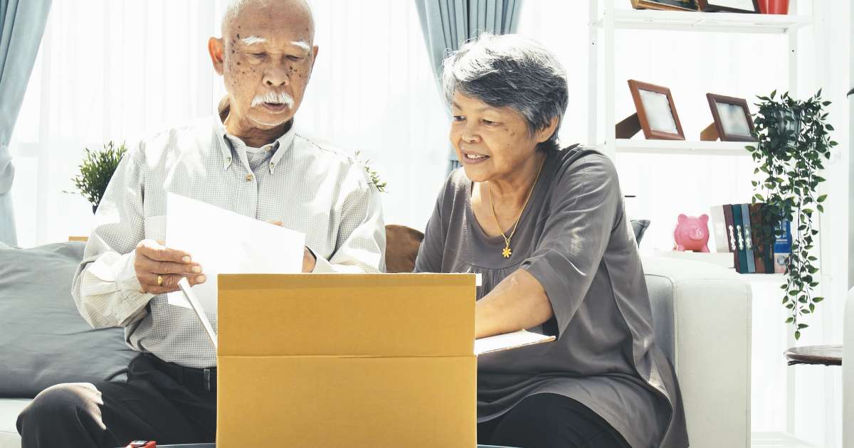 older couple packing boxes